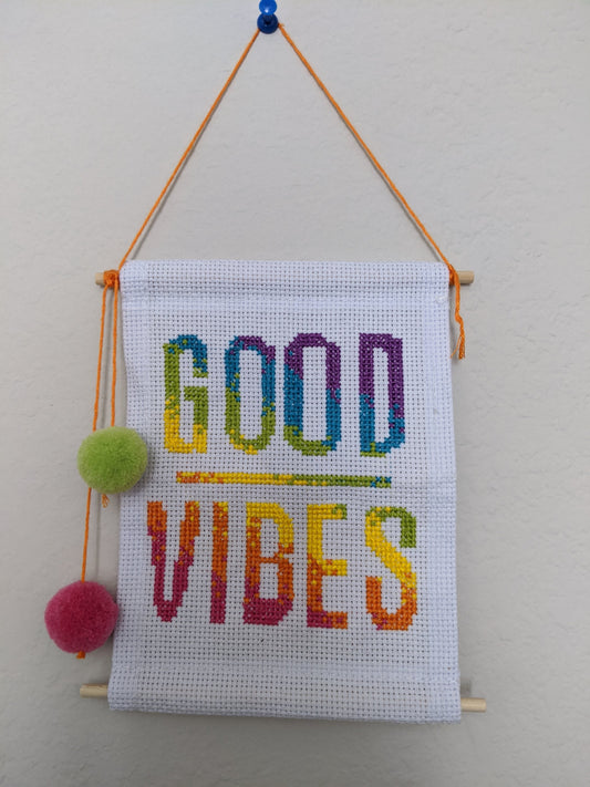 Handmade cross stitched good vibes wall hanging.